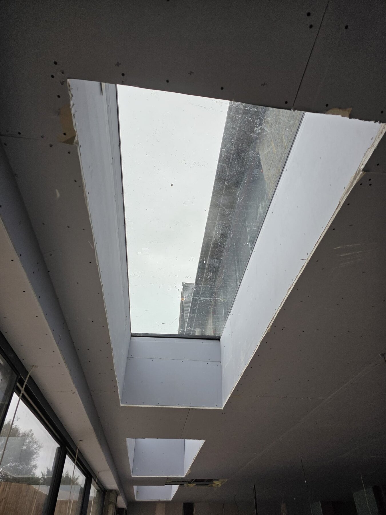 Plasterboard ceiling and skylight reveals during a drylining installation