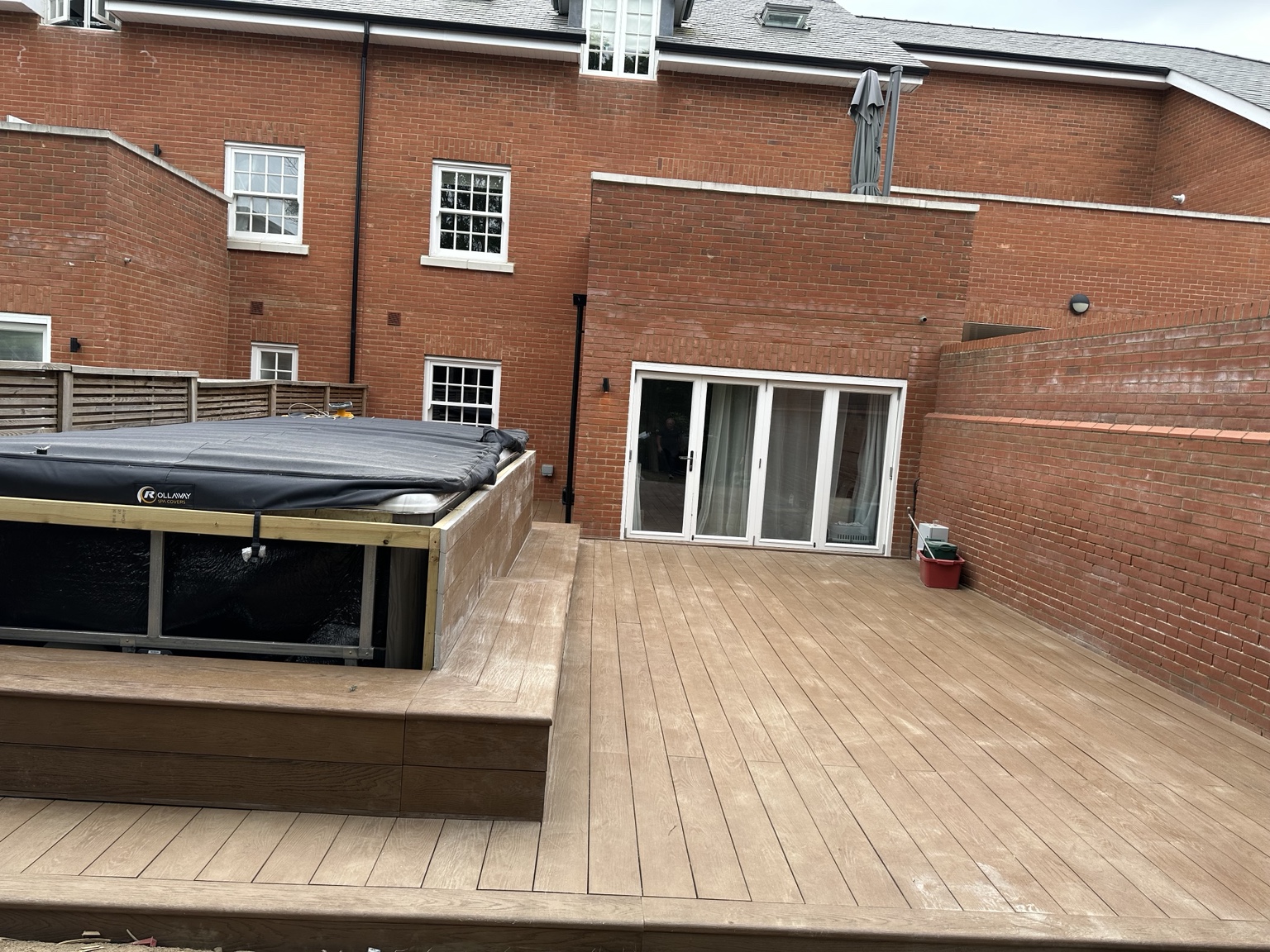Completed composite decking across a large rear garden