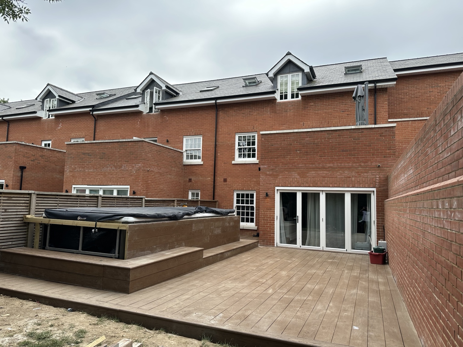 Completed composite decking with integrated hot-tub surround