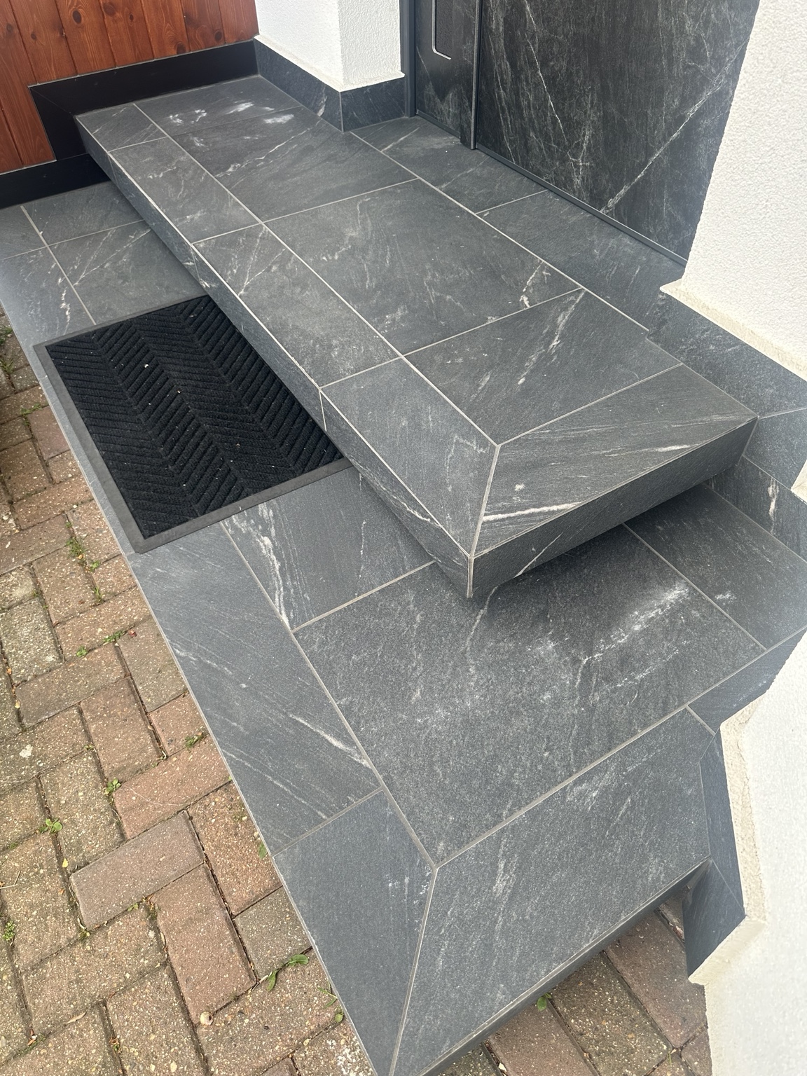 Completed dark tiled exterior entrance steps